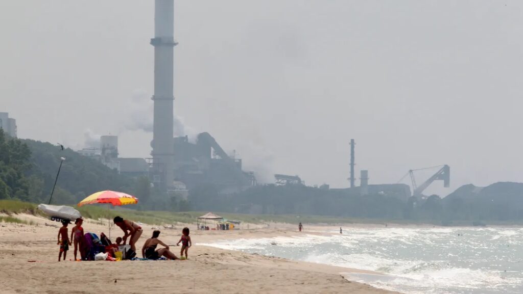 People enjoy the beach on the Indiana shore of Lake Michigan, east of ArcelorMittal’s Burns Harbor steel mill. Credit: Kelly Wilkinson/The Star 2012 File Photo
