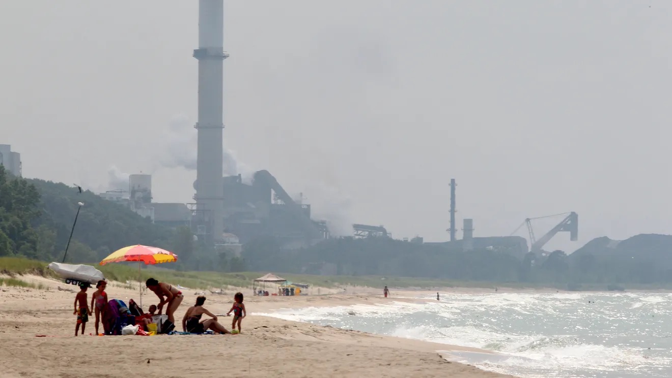 People enjoy the beach on the Indiana shore of Lake Michigan, east of ArcelorMittal’s Burns Harbor steel mill. Credit: Kelly Wilkinson/The Star 2012 File Photo